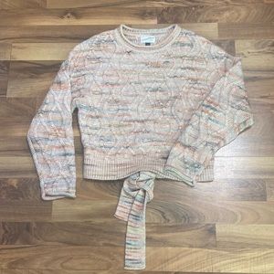 Multi colored women’s sweater with tie back.